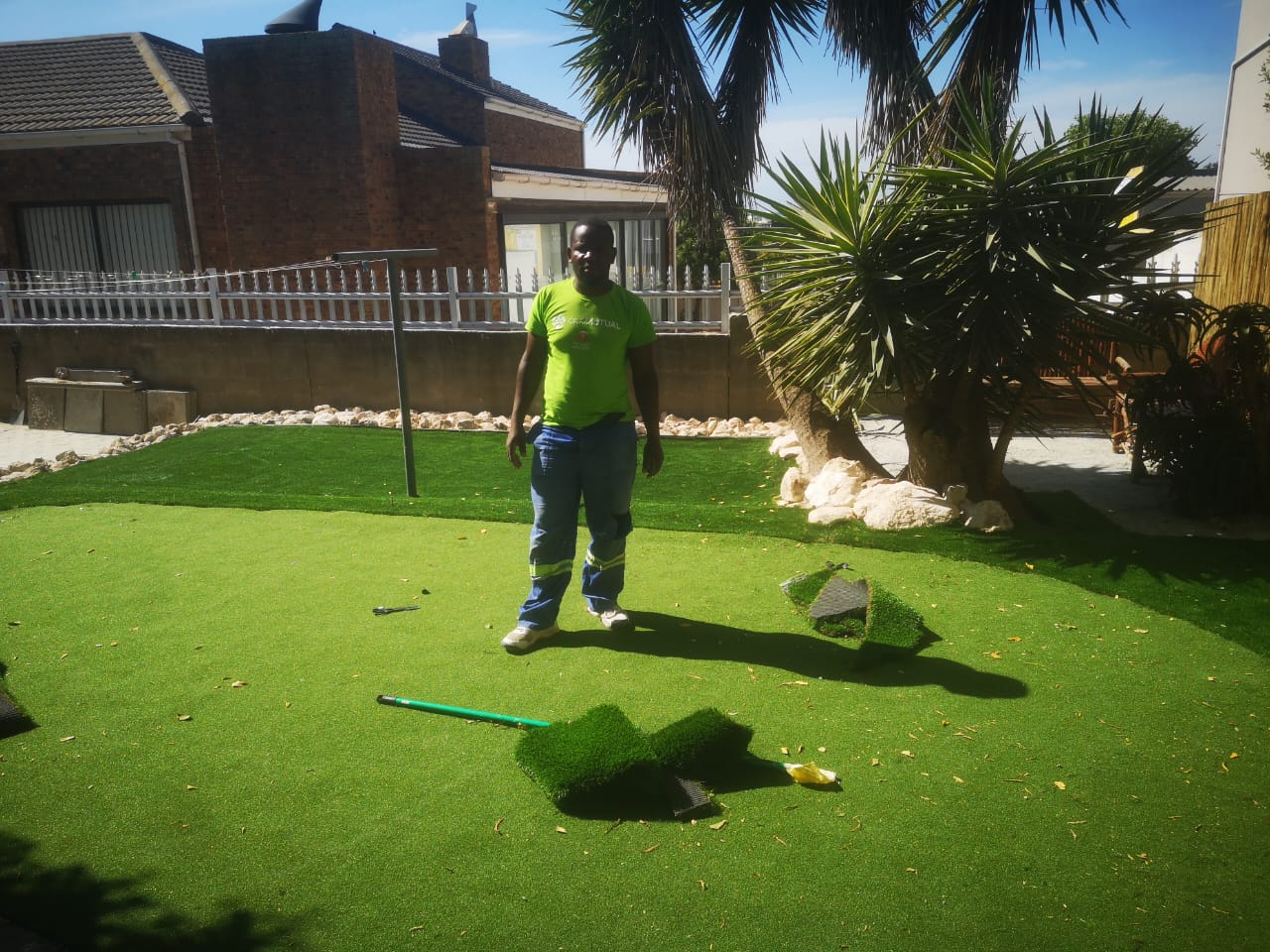 Artificial lawn installation in a landscaped West Coast garden